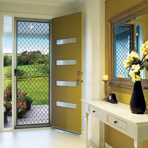 Interior of a home, looking out through diamond grille security door.