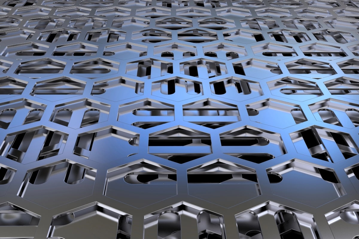 Close-up of a perforated sheet metal with a hexagonal pattern.