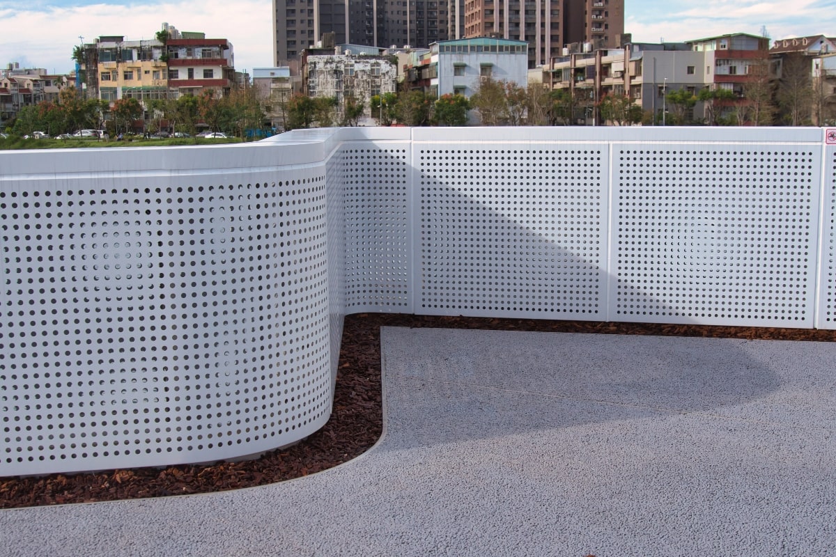 Curved metai fence, an example of the many uses of perforation.